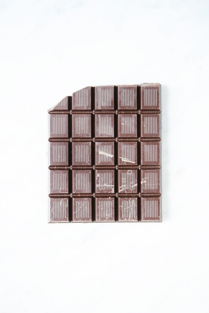 Dark chocolate bar on white background.