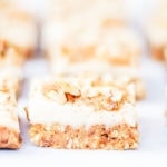 Carrot cake bars with vegan cream cheese frosting, photographed from the side.