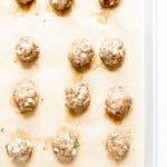 Turkey zucchini meatballs on a baking tray.