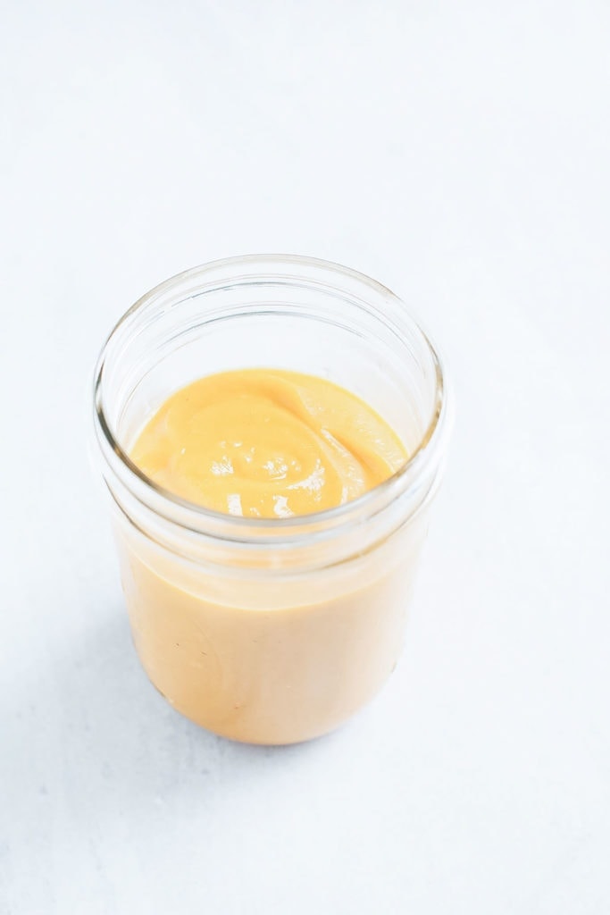 Creamy vegan butternut squash sauce in a glass jar.