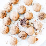 Chocolate collagen energy bites on a white plate.