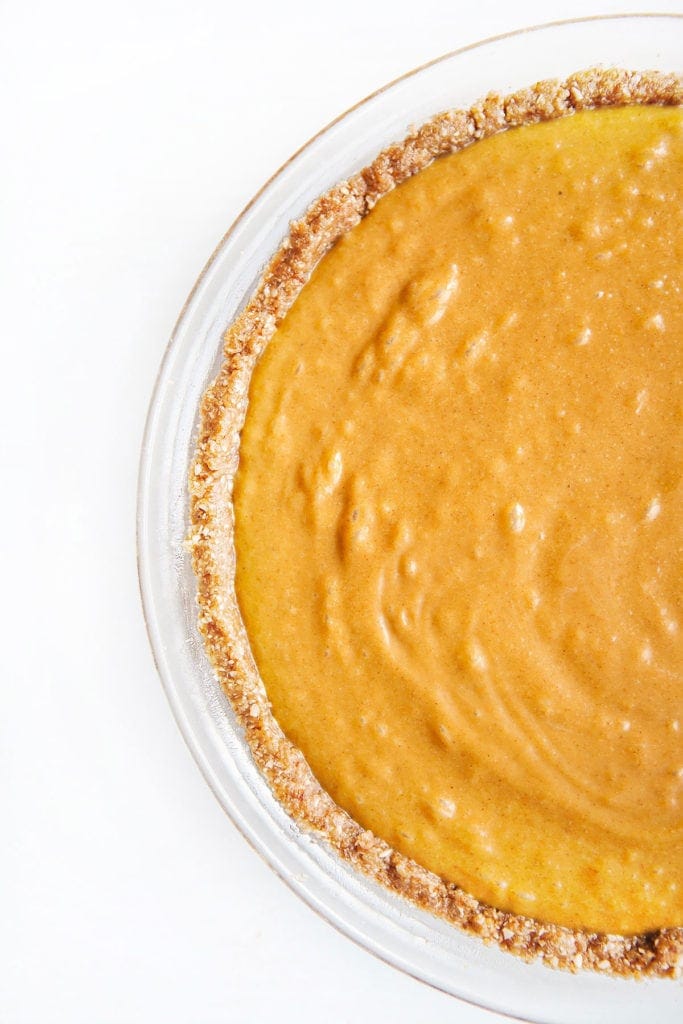 Gluten-free, dairy-free pumpkin pie in a pie pan, unbaked.