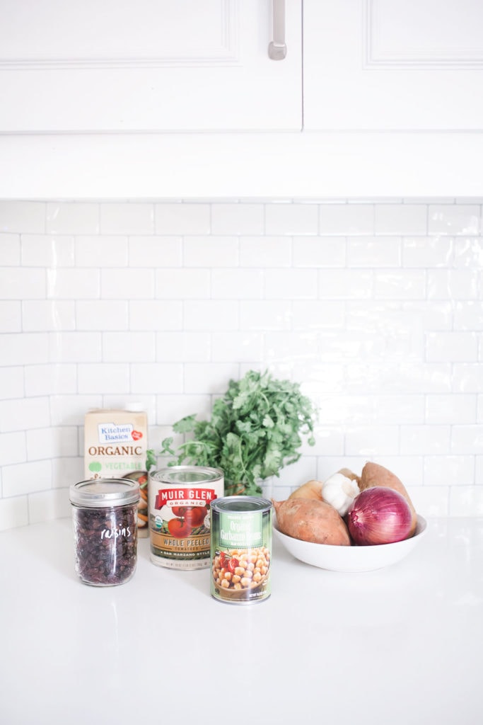 Ingredients on a white kitchen counter with white subway tile in the background.