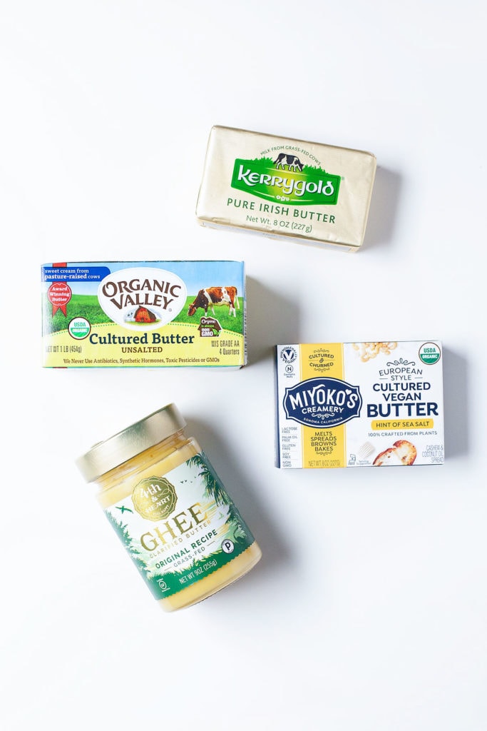 Butter, ghee, and vegan butter on a white background.