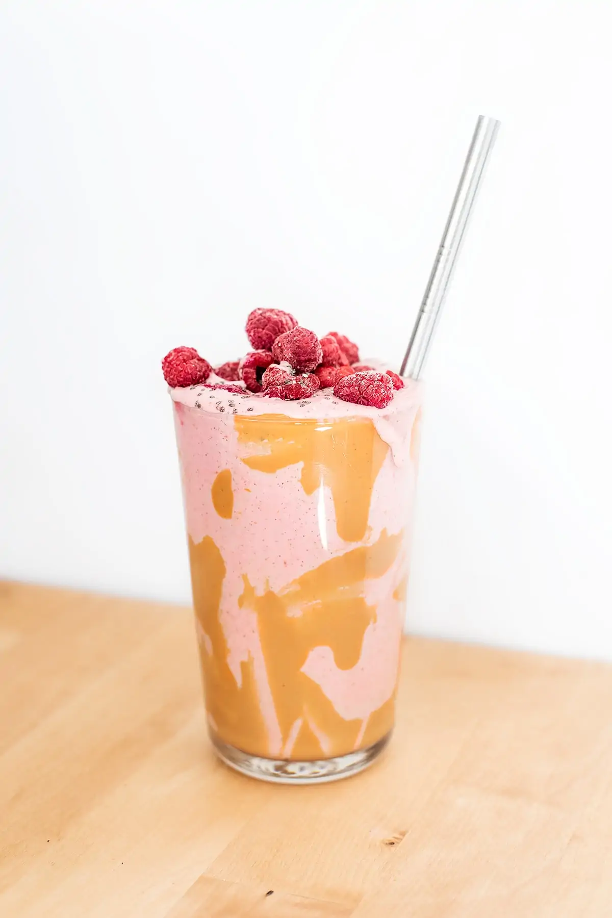 Pink peanut butter and jelly smoothie with raspberries